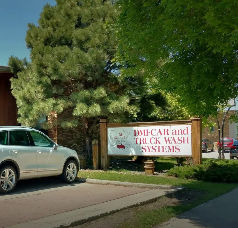 The DMI-Car and Truck Wash Systems sign outside the office at 909 Page Drive, Fargo
